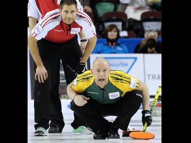 Northern Ontario second E.J. Harnden and Team Canada third John Morris watch Northern Ontario skips'  Brad Jacobs shot during  the gold medal final of the 2015 Tim Hortons Brier on Sunday March 8, 2015.