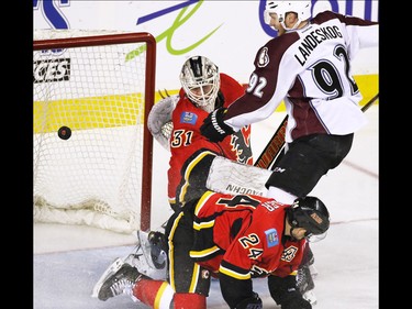 Calgary Flames goaltender Karri Ramo watch this shot go wide as flames centre Jiri Hudler and Colorado Avalanche forward Gabriel Landeskog fight for position during first period NHL action at the Scotiabank Saddledome Monday March 23, 2015.