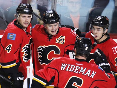 Calgary Flames, from left, Kris Russell, Jiri Hudler, Dennis Wideman and Johnny Gaudreau celebrate Hudler's goal in the closing seconds of first period NHL action at the Scotiabank Saddledome Monday March 23, 2015.