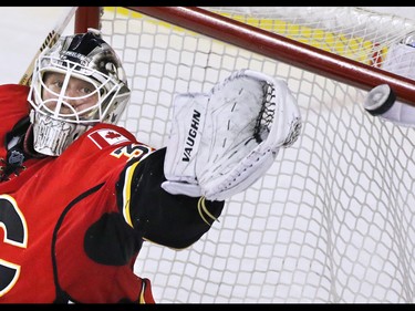 Calgary Flames goaltender Karri Ramo reaches for a Colorado Avalanche shot as it bounces off the cross bar during second period NHL action at the Scotiabank Saddledome Monday March 23, 2015.