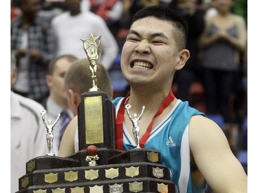 Captain Jairus De Jesus holds the trophy after his Bishop McNally Timberwolves defeated the Sir Winston Churchill Bulldogs to win the City High School Division One Basketball Championships Saturday night  March 14, 2015 at the University of Calgary.