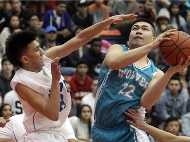 Jairus De Jesus gets a shot off past Nico Ogawa of the Sir Winston Churchill Bulldogs during the City High School Division One Basketball Championship, Saturday night  March 14, 2015 at the University of Calgary.