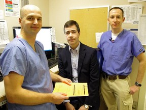 Dr. James Andruchow, left, and Dr. Andrew McRae, right, chat with Juan Garcia, 45, a study participant.