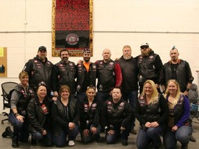 Group shot of BACA, Bikers Against Child Abuse. The group has been vocally in support of Kyla Woodhouse at the first degree murder trial of Spencer Jordan and Marie Magoon in connection with the death of Kyla's daughter Meika Jordan. Kyla is in the centre on the bottom row and her husband Brian Woodhouse is in the middle of the back row.