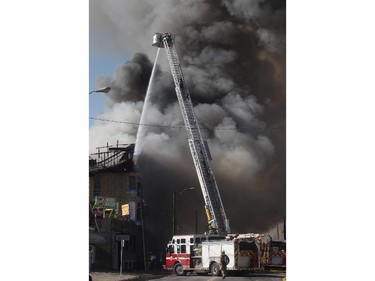 Flames engulf a building under construction at 17th Avenue South and Centre Street Saturday afternoon March 7, 2015.