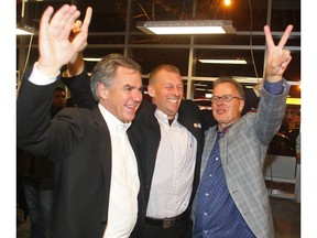 Victorious Tories, from left, Premier Jim Prentice, Mike Ellis and Gordon Dirks celebrate after winning their ridings, Calgary-Foothills, Calgary-Elbow and Calgary West, in the October 2014 byelections.