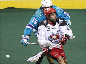 Shawn Evans, seen battling Rochester's Sid Smith during the Champions Cup final last season, led Calgary's effort against Rochester on Saturday night with three goals and five assists.