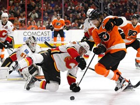 Calgary Flames defenceman T.J. Brodie blocks Claude Giroux of the Philadelphia Flyers on Tuesday night. Brodie later set up Jiri Hudler's beautiful overtime winner.