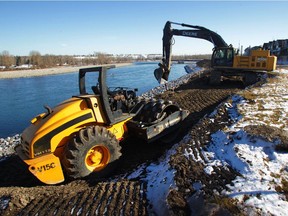 Heavy equipment works on the Bow River bank stabilization along 8th Avenue in Inglewood. Reader says city must build both rivers' berms higher.