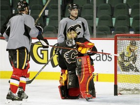 Jonas Hiller, with teammates Corey Potter and Raphael Diaz, practises on Sunday. A hot goalie is one of the key ingredients for the Calgary Flames as they finish off the season in the hunt for a playoff spot.