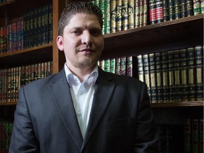 Mahdi Qasqas, president of OWN Cultural Brokerage Program, poses in the library of the Islamic Centre of Calgary on Aug. 29, 2014.