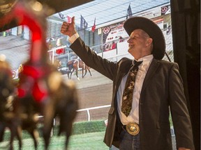 Kelly Sutherland gives the thumbs up after Friends of the King buys his canvas for $95,000 at the 2015 GMC Rangeland Derby Canvas Auction at the Boyce Theatre at Stampede Park in Calgary, on March 19, 2015.