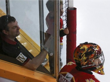 A young fan tries to get a bit closer to the action on the University of Calgary Dinos bench during CIS playoff action at Father David Bauer arena in Calgary, on March 1, 2015.