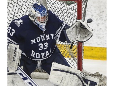 Mount Royal Cougars' goalie Dalyn Flette makes the save during CIS playoff action against the University of Calgary Dinos at Father David Bauer arena in Calgary, on March 1, 2015.