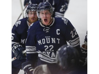 Mount Royal Cougars' Matthew Brown is pumped after scoring during CIS playoff action against the University of Calgary Dinos at Father David Bauer arena in Calgary, on March 1, 2015.
