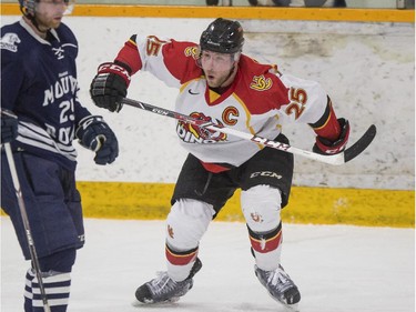 Calgary Dinos' Kevin King celebrates scoring the first goal of the game during CIS playoff action at Father David Bauer arena in Calgary, on March 1, 2015.