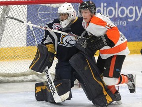 Drumheller's Jacob Schofield gets in the face of Calgary Mustangs goalie Ravi Dattani during an AJHL game last month. Schofield and the rest of the Dragons will kick off the AJHL playoffs against Olds on Wednesday night.