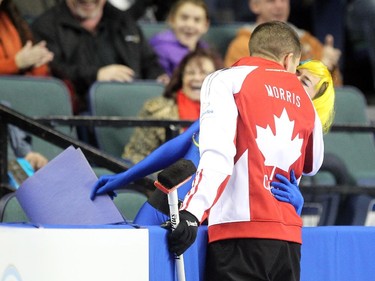Lac La Biche's Danika Richard got a kiss from Team Canada Skip John Morris  in between the 6th and 7th ends during the Tim Hortons Brier at the Scotiabank Saddledome on March 1, 2015.