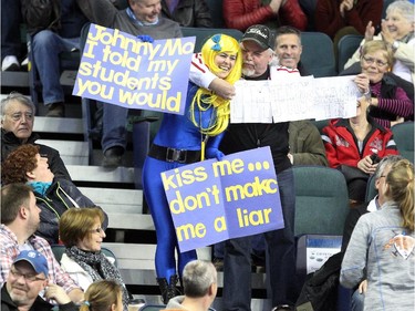 Lac La Biche's Danika Richard got a kiss from Calgary's Bob Keith, who held up his own sign saying he was Johnn's Mo's stand-in as Richard tried to get a kiss from Team Canada Skip John Morris during the Tim Hortons Brier at the Scotiabank Saddledome on March 1, 2015.
