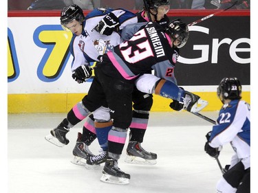 Calgary Hitmen left winger Taylor Sanheim and Kootenay Ice centre Matt Alfaro collided in the Hitmen zone during first period WHL action at the Scotiabank Saddledome on March 22, 2015.