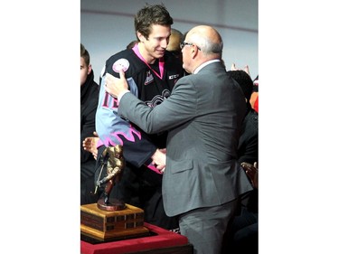 Calgary Hitmen centre Adam Tambellini shook the hand of Ken King after he was named the player of the year prior to the game against the Kootenay Ice during WHL action at the Scotiabank Saddledome on March 22, 2015.