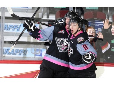 Calgary Hitmen left winger Kenton Helgesen, left, and centre Pavel Karnaukhov celebrated after scoring against the Kootenay Ice during second period WHL action at the Scotiabank Saddledome on March 22, 2015.