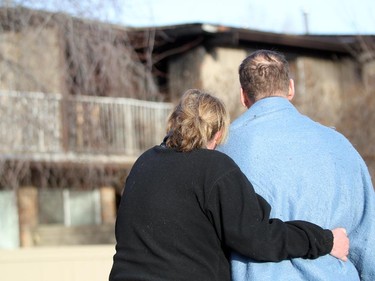 Tracey Fagan, left, and her fiancé Brooke Vance hugged as they looked on to their Huntington Hills townhouse unit which caught fire around 6 am on March 5, 2015.