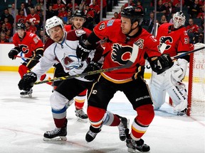 Calgary Flames defenceman Dennis Wideman skates against Colorado's Tyson Barrie on Monday night. When Dallas visits on Wednesday, it will mark the rearguard's 700th NHL game.