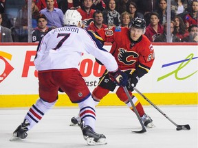 Calgary Flames forward Markus Granlund carries the puck against Columbus' Jack Johnson at the Scotiabank Saddledome.