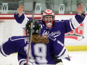 University of Western Ontario Mustangs goalie Kelly Campbell raises her arms in triumph at the buzzer as Western defeats McGill 5-0 to win the CIS women's hockey crown on Sunday at the Markin MacPhail Centre in Calgary.