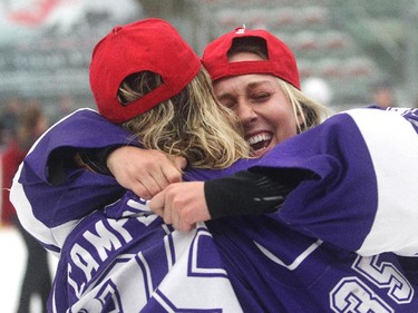 University of Western Ontario Mustangs goalie Kelly Campbell, left, is embraced by fellow goalie Peyton Parker after the buzzer as Western defeats McGill 5-0 to win the CIS Women's Hockey crown Sunday  March 15, 2015 at Winsport.