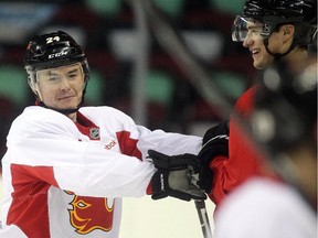 Calgary Flames forward Jiri Hudler jokingly jousts with teammate Joe Colborne at practice Tuesday March 10, 2015 in advance of Wednesday's game against the Anaheim Ducks.