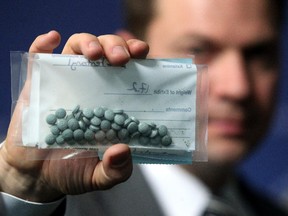 Calgary Police Service Staff Sgt. Martin Schiavetta, of the CPS Drug Unit, held an evidence bag with seized Fentanyl tablets during a press conference to raise awareness around the street drug on March 25, 2015.