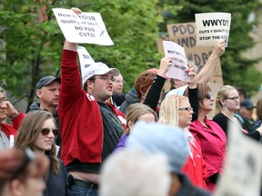 People protesting 2013 against cuts to Alberta's social services budget.