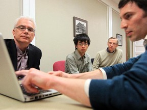 From left, Greg Miller, Jeremy Zhao, Bob Morrison and Benjamin Israel take part in a meeting of CivicCamp, a grassroots group involved in municipal politics, in Calgary, Alberta Tuesday, April 30, 2013.