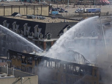 Smoke and fire engulf a building construction site at the corner of 17 Ave and Centre St SW in Calgary, on March 7, 2015.