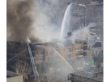 Smoke and fire engulf a building construction site at the corner of 17 Ave and Centre St SW in Calgary, on March 7, 2015.