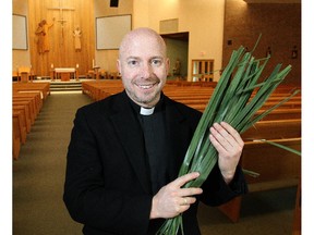 Father Jerome Lavigne of St. Peter's Roman Catholic Church holds palm fronds in advance of Palm Sunday at the church Monday March 23, 2015.