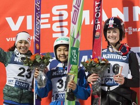 Gold winner Sara Takanashi of Japan, centre, is flanked on the podium by silver winner Sarah Hendrickson, left, of the U.S., and bronze winner Taylor Henrich of Canada, as they celebrate after the FIS World Cup Ladies Ski Jumping competition in Oslo, Norway, Friday March 13, 2015.