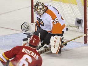 Calgary Flames defenceman Dennis Wideman buries one behind Philadelphia Flyers goalie Steve Mason on Thursday night.