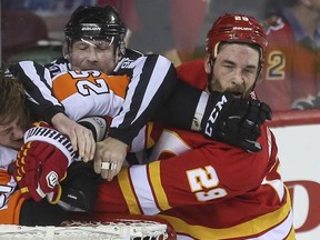 Calgary Flames defenceman Deryk Engelland takes a jab from Philadelphia Flyers forward (and former Calgary Hitmen star) Ryan White on Thursday.