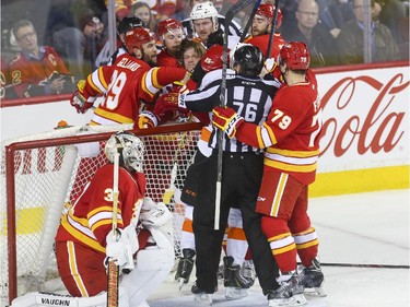 The Calgary Flames and Philadelphia Flyers duke it out during NHL action at the Saddledome in Calgary, on March 19, 2015.