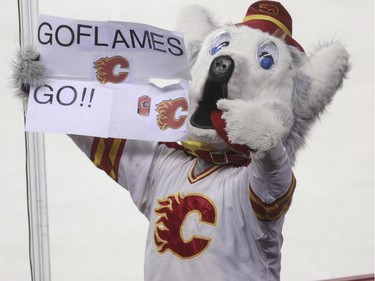 Calgary Flames Harvey the Hound gets fans chanting during third period action against the Philadelphia Flyers at the Saddledome in Calgary, on March 19, 2015.