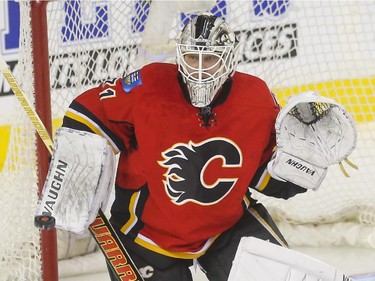 Calgary Flames goalie Karri Ramo eyes down the puck during game action against the Dallas Stars at the Saddledome in Calgary, on March 25, 2015.