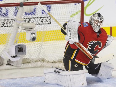 Calgary Flames goalie Karri Ramo barely makes this save during game action against the Dallas Stars at the Saddledome in Calgary, on March 25, 2015.