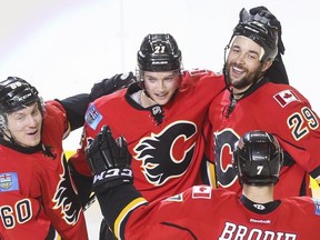 Calgary Flames Markus Granlund, from left, Mason Raymond, Deryk Engelland  and TJ Brodie, celebrate Engelland's second goal of the game against Dallas on Wednesday night. Calgary lost 4-3 in their final game of a homestand before embarking on a five-game road trip, which begins on Friday in Minnesota.