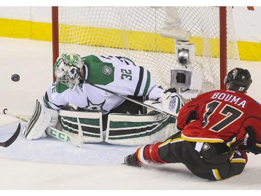 Calgary Flames Lance Bouma came in hard on a break away but couldn't bury it against Dallas Stars goalie Kari Lehtonen during game action at the Saddledome in Calgary, on March 25, 2015.