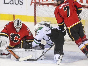 The Dallas Stars Ales Hemsky falls into the net which disqualified what would have been the winning goal during third period action against the Flames at the Saddledome in Calgary, on March 25, 2015.