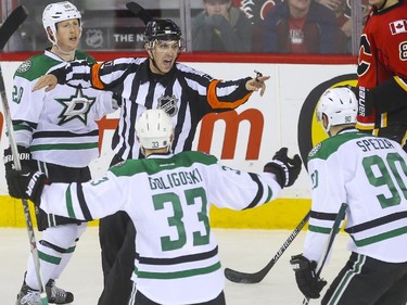 The Dallas Stars are unimpressed as referee Frederick L'Ecuyer waves off what would have been the winning goal during third period action against the Flames at the Saddledome in Calgary, on March 25, 2015.