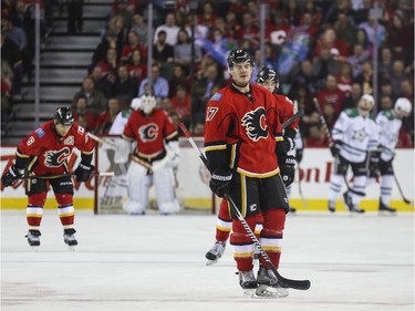 Calgary Flames Lance Bouma, centre, Dennis Wideman, left, and Sean Monahan skate away from goalie Karri Ramo after the Dallas Stars score to take the lead during game action at the Saddledome in Calgary, on March 25, 2015.